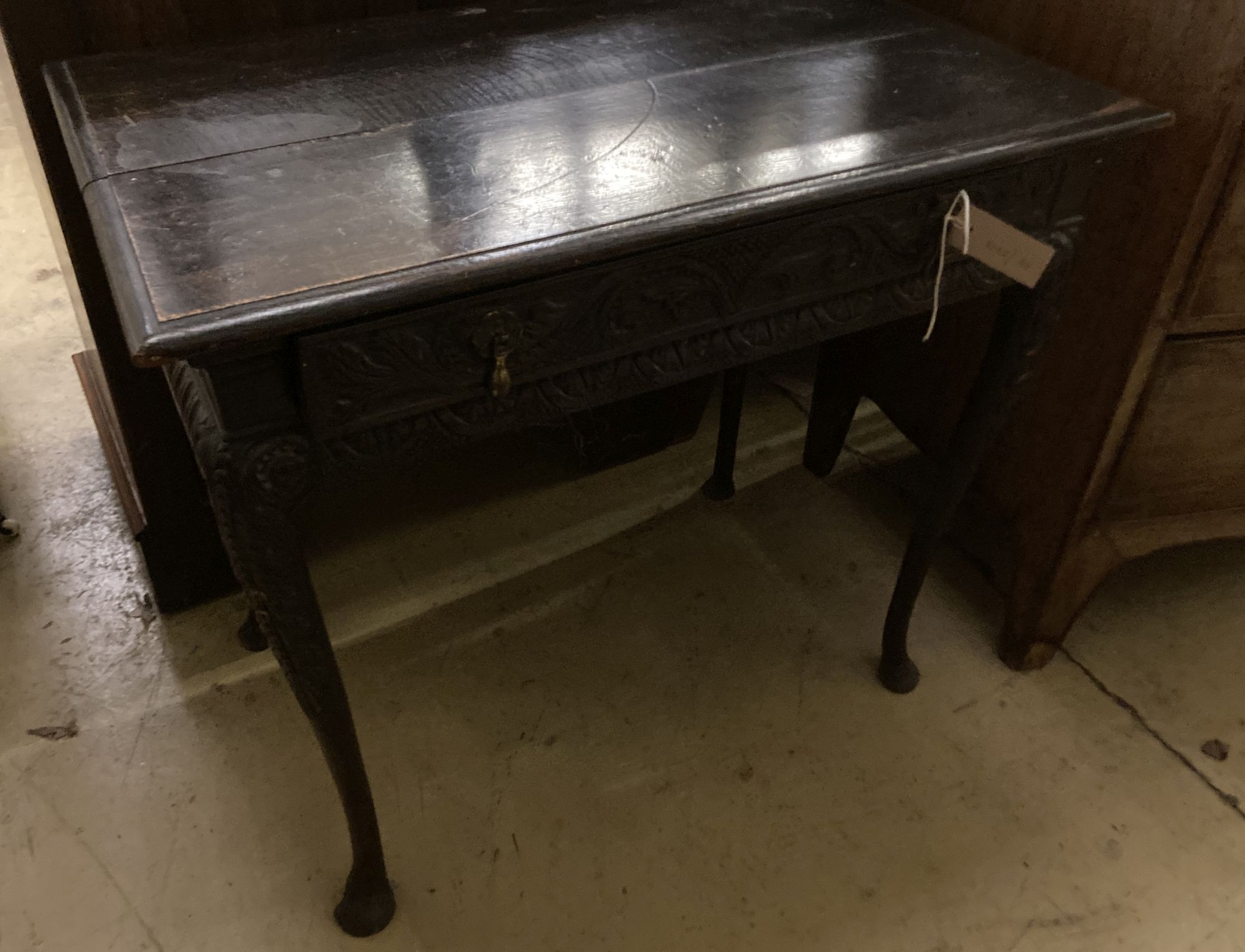 An 18th century oak side table, fitted single long drawers, later carved front, on cabriole supports, width 75cm, depth 47cm, height 66